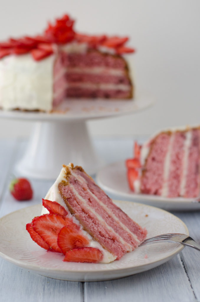 This strawberry layer cake with cream cheese frosting is a beautiful, tasty, seasonal cake to do asap as it is the perfect pre-summer cake!