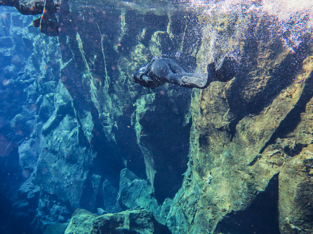 Silfra fissure is a place in Iceland where the Eurasian and North American continents drift apart and you can swim in between those two tectonic plates!